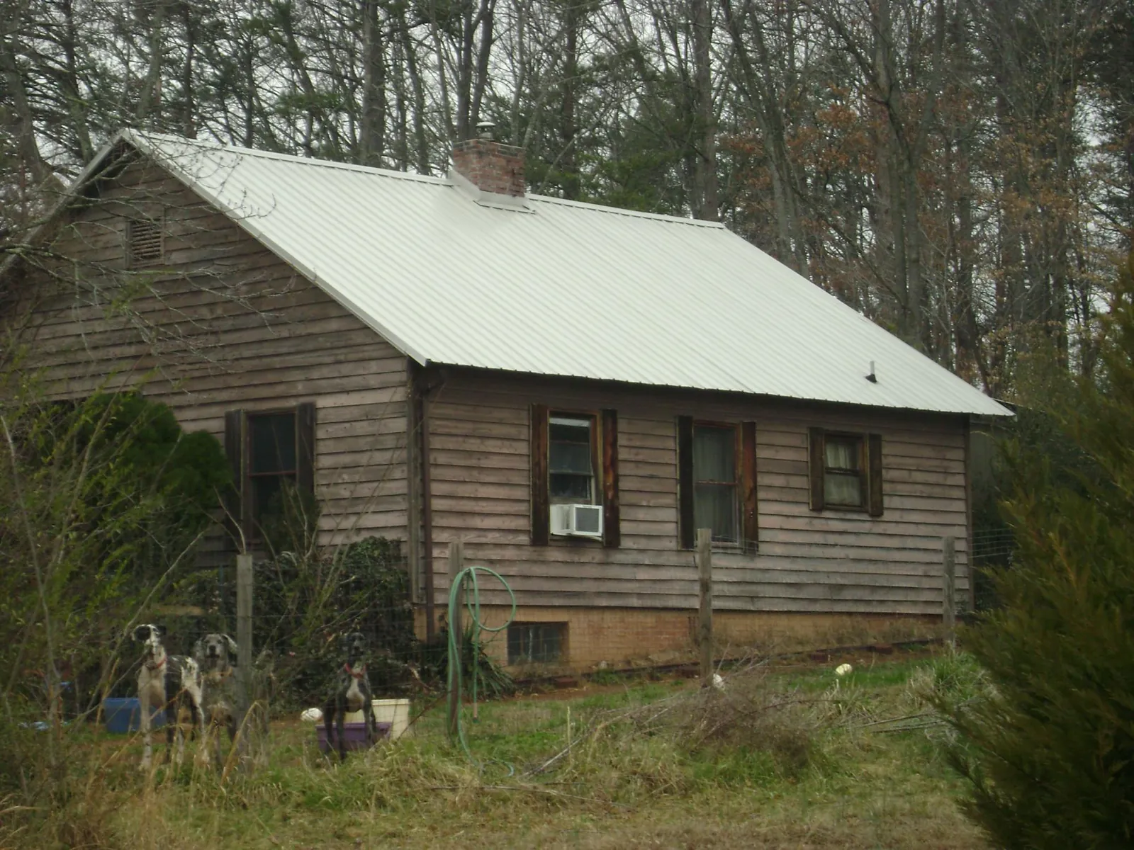 White metal roof on an old wood sided farmhouse, from a Asphalt Shingle Roof Repair job in Jefferson Valley